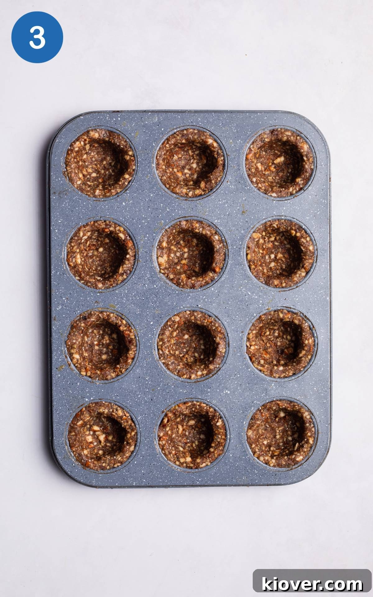 12 cupcake cases inside a cupcake baking tray.