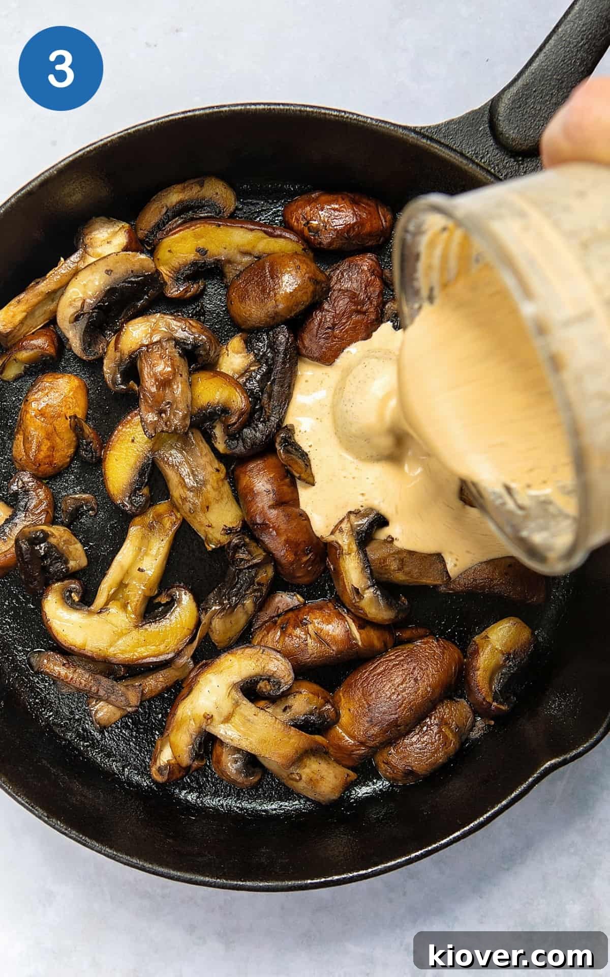 Creamy Mushroom Alfredo Pasta Recipe for Dinner 6 Pouring the blended sauce in a pan with the mushrooms.